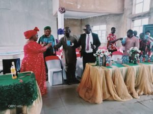 Rev. Mrs. Ijeoma toasting to long live and prosperity with her Church members